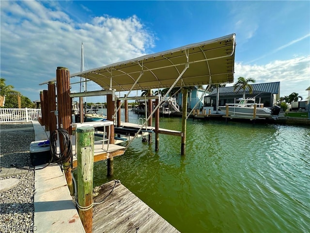 view of dock with a water view and boat lift