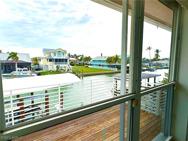 balcony with a residential view and a water view