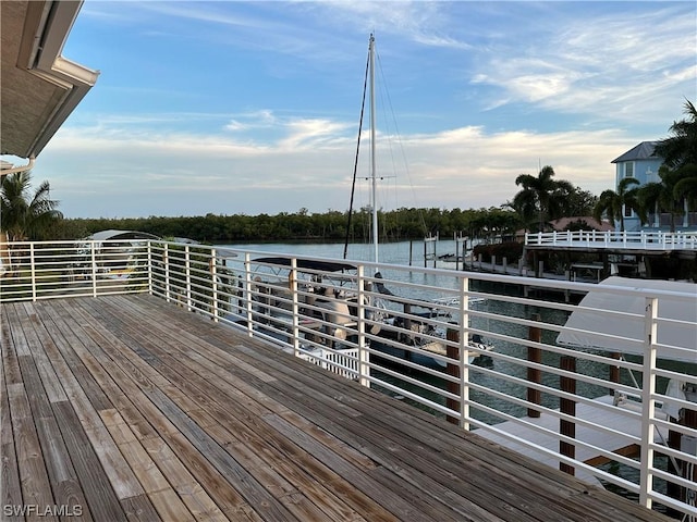 dock area featuring a balcony and a water view