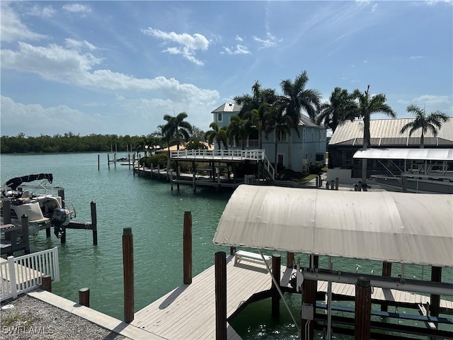 dock area with a water view and boat lift