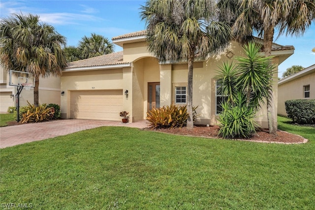 mediterranean / spanish-style house with a front yard and a garage