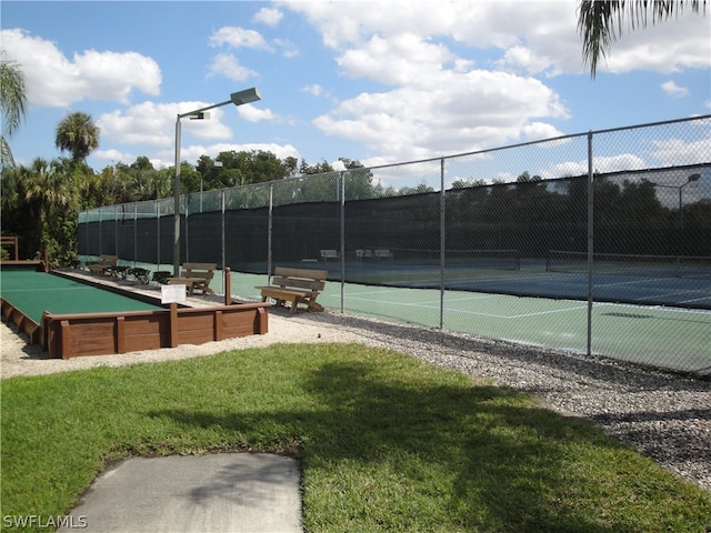 view of sport court featuring a yard