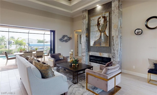 living room featuring a towering ceiling and a fireplace