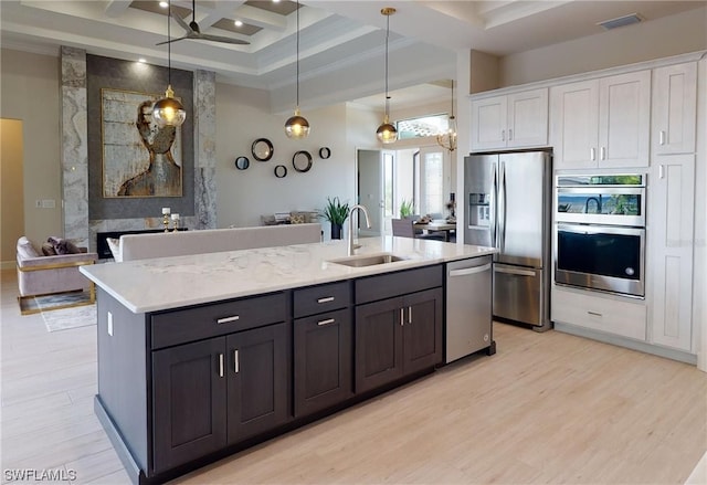 kitchen featuring ceiling fan, light hardwood / wood-style flooring, coffered ceiling, stainless steel appliances, and white cabinetry