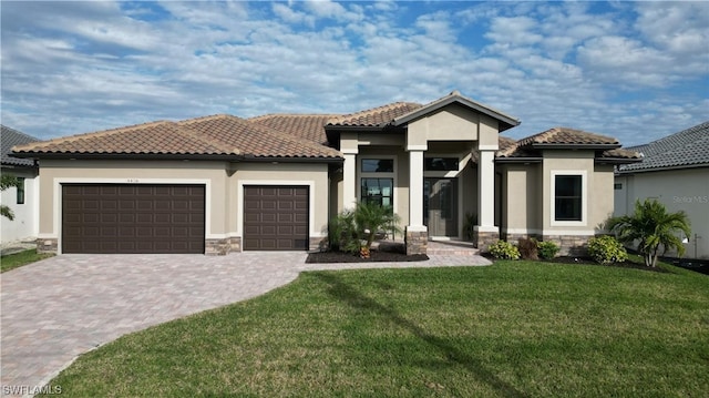 mediterranean / spanish-style house featuring a front lawn and a garage