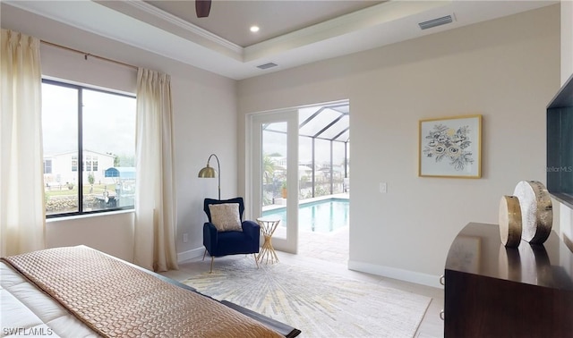 bedroom featuring a tray ceiling and access to exterior