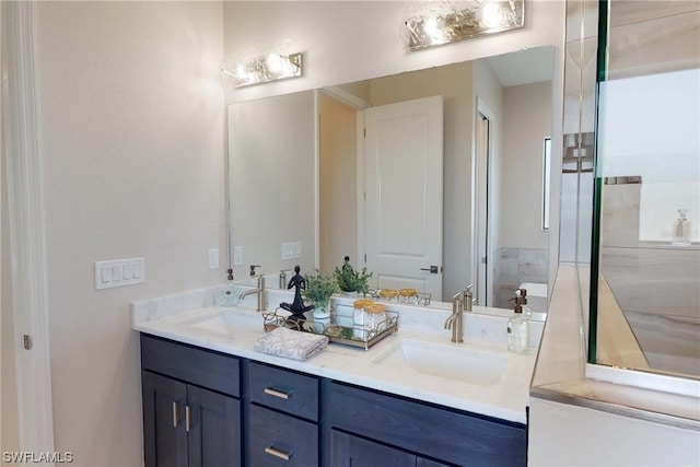 bathroom with dual sinks and vanity with extensive cabinet space