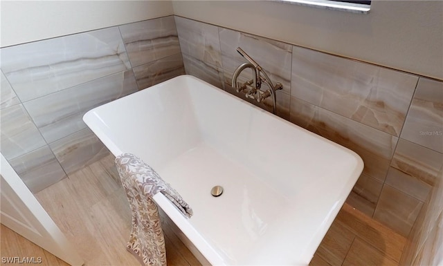 room details featuring a bath and tile floors