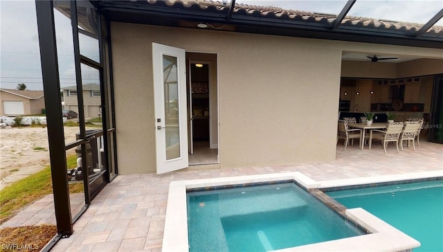 view of swimming pool with ceiling fan and a patio