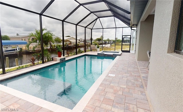 view of swimming pool with a patio area, an in ground hot tub, and glass enclosure