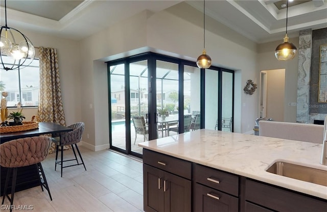 interior space with an inviting chandelier, light stone countertops, decorative light fixtures, and a fireplace