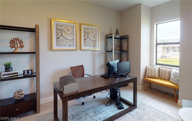 office with light hardwood / wood-style flooring