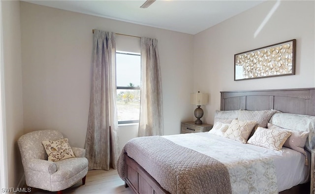 bedroom with ceiling fan and light hardwood / wood-style flooring