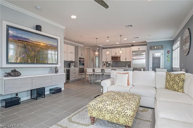 tiled living room with crown molding and beverage cooler