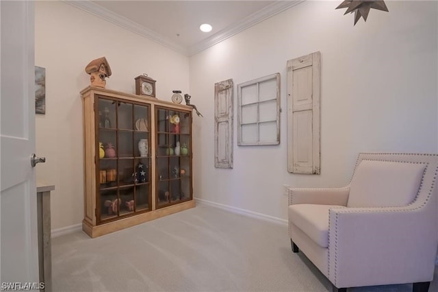 sitting room with light carpet and ornamental molding