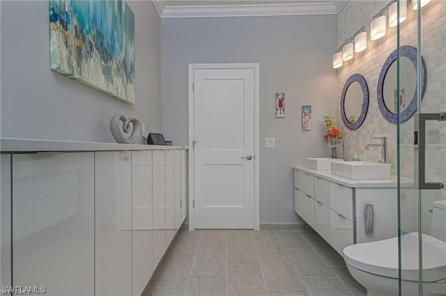 bathroom featuring tile patterned flooring, vanity, toilet, and ornamental molding