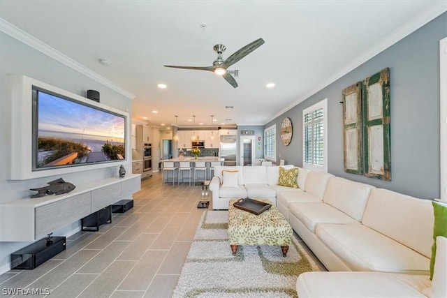 living room with crown molding and ceiling fan