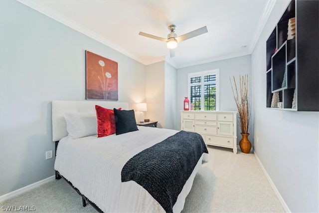 carpeted bedroom with ceiling fan and ornamental molding