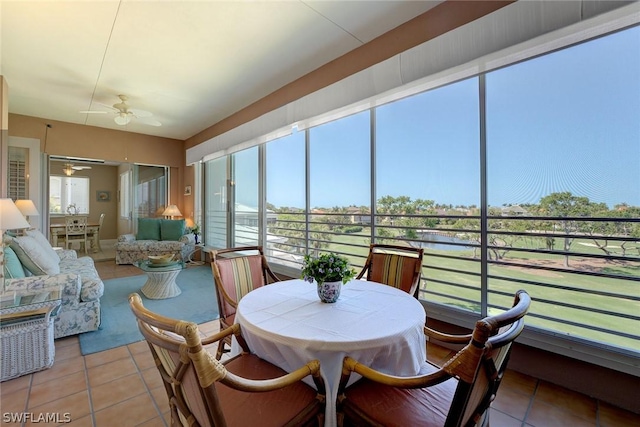 sunroom featuring ceiling fan and a healthy amount of sunlight