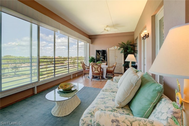 sunroom / solarium featuring ceiling fan