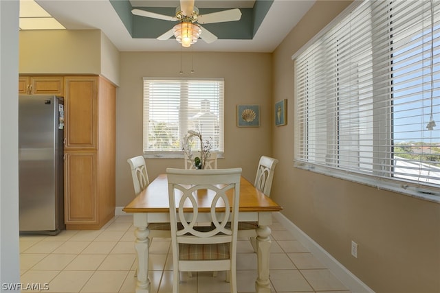 dining space featuring ceiling fan and light tile patterned floors