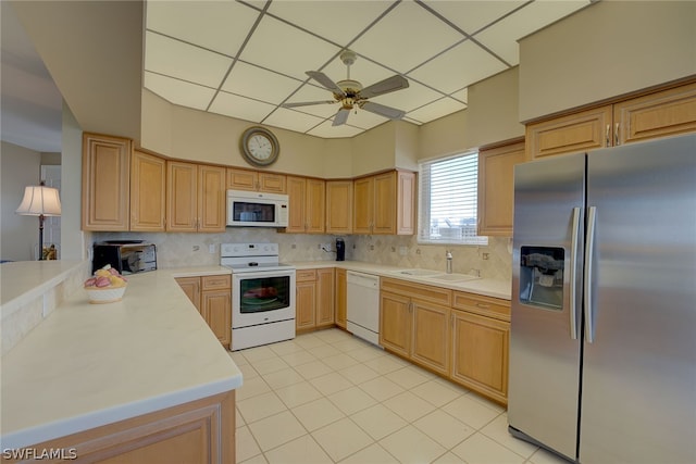 kitchen with decorative backsplash, ceiling fan, white appliances, and sink