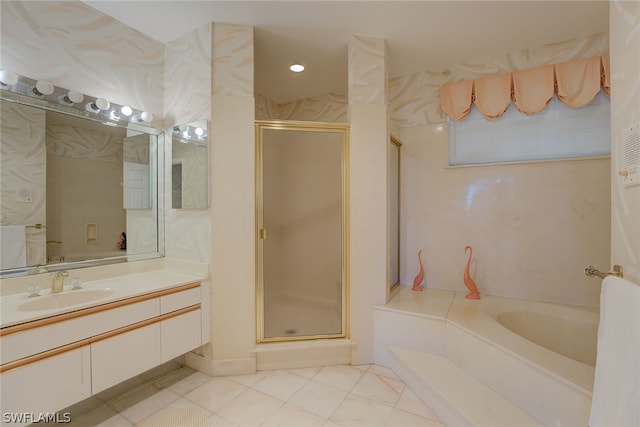 bathroom featuring plus walk in shower, vanity, and tile patterned flooring