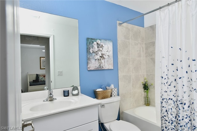 full bathroom with shower / bath combo with shower curtain, toilet, and vanity