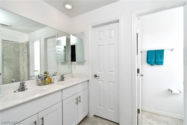 bathroom featuring a shower with door, dual bowl vanity, and tile floors