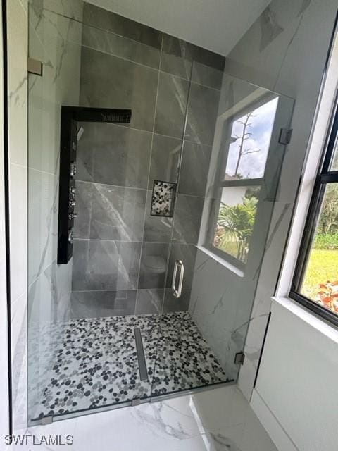 bathroom with a shower with shower door