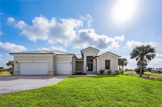 view of front of home with a garage and a front yard