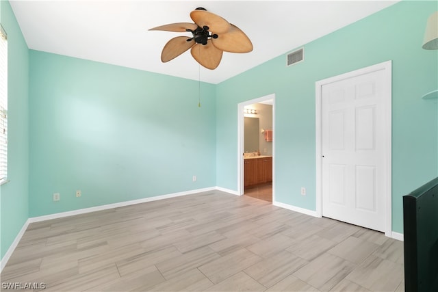 unfurnished bedroom with connected bathroom and ceiling fan