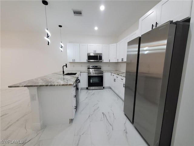 kitchen with white cabinets, decorative light fixtures, light stone countertops, and appliances with stainless steel finishes