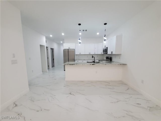 kitchen with kitchen peninsula, light stone countertops, stainless steel appliances, pendant lighting, and white cabinetry