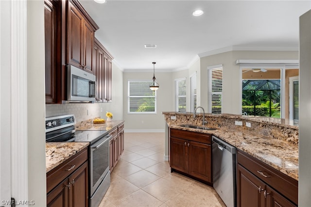 kitchen with sink, crown molding, light tile patterned floors, appliances with stainless steel finishes, and pendant lighting