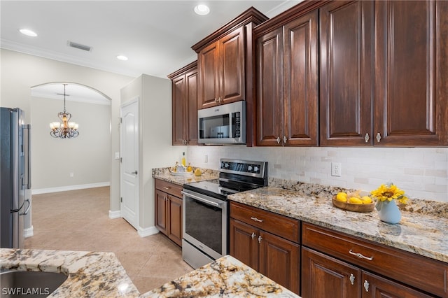 kitchen featuring crown molding, stainless steel appliances, light stone countertops, and light tile patterned floors