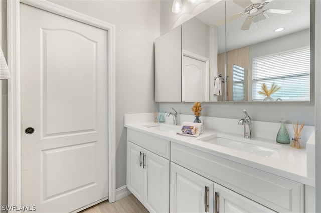 bathroom featuring vanity, hardwood / wood-style flooring, and ceiling fan