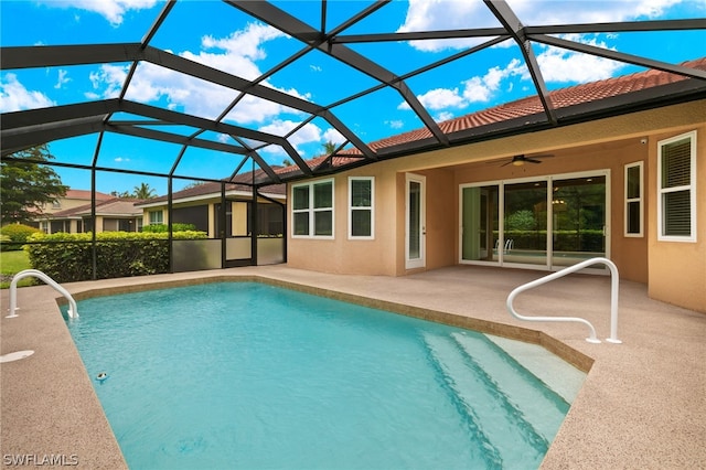 view of swimming pool with a lanai, a patio area, and ceiling fan