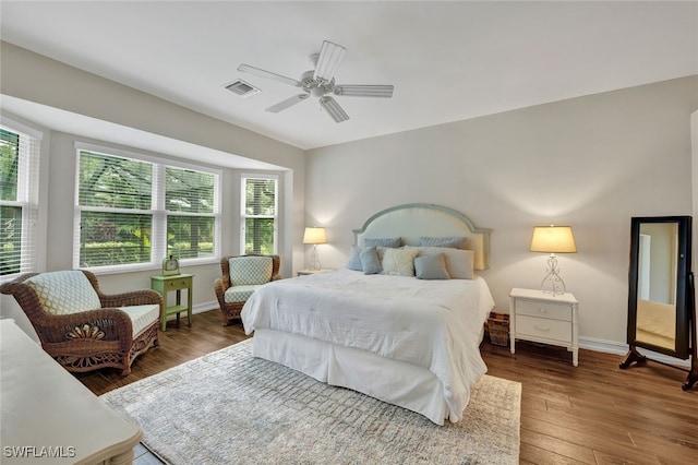 bedroom with dark hardwood / wood-style floors and ceiling fan