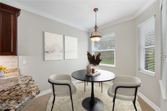 dining area with ornamental molding and light tile patterned floors