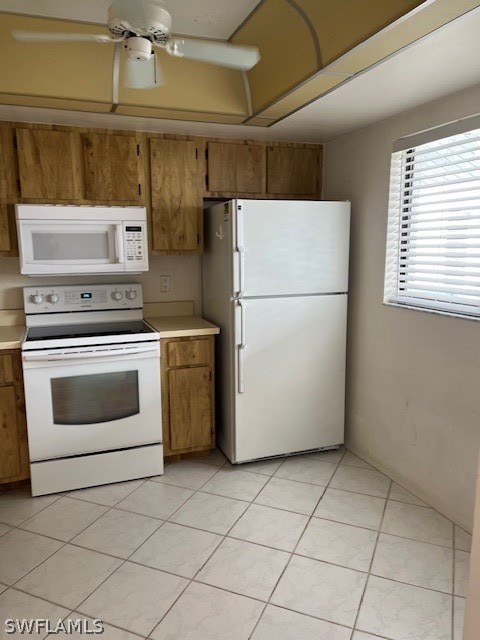 kitchen featuring white appliances, ceiling fan, and light tile floors