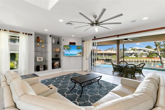 living room featuring ceiling fan and light tile patterned floors