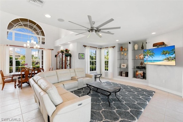 tiled living room with recessed lighting, visible vents, baseboards, and ceiling fan with notable chandelier