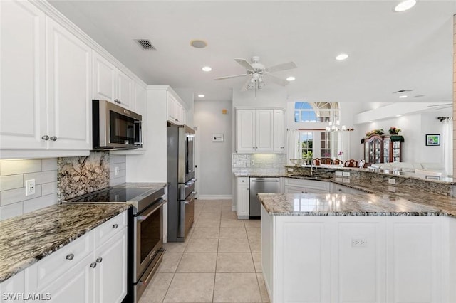 kitchen featuring visible vents, appliances with stainless steel finishes, light tile patterned flooring, ceiling fan, and white cabinetry