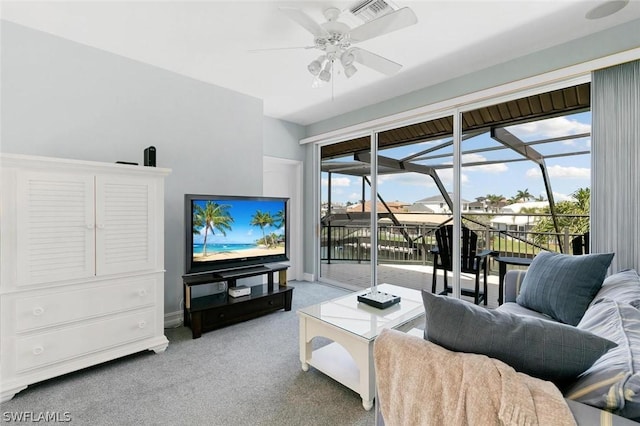 living area with visible vents, plenty of natural light, a sunroom, and light colored carpet