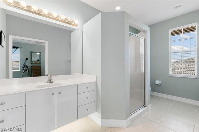 bathroom with toilet, vanity, tile patterned floors, and walk in shower