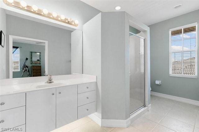 full bathroom featuring a wealth of natural light, tile patterned flooring, a shower stall, and vanity