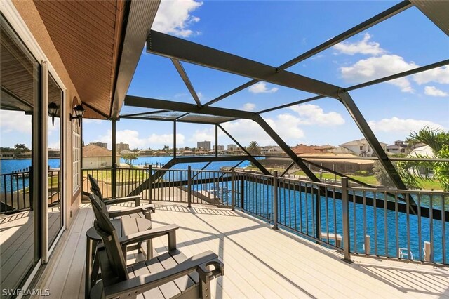 wooden deck featuring a lanai, a water view, and a swimming pool