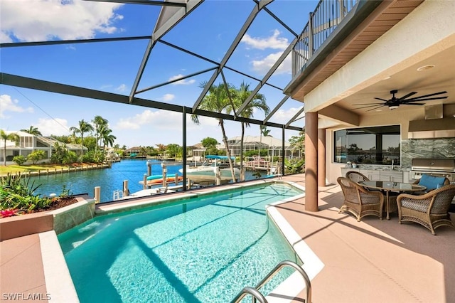 view of pool featuring glass enclosure, ceiling fan, a dock, a water view, and a patio area