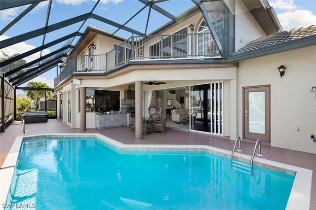 rear view of house with a balcony, a lanai, and a patio area